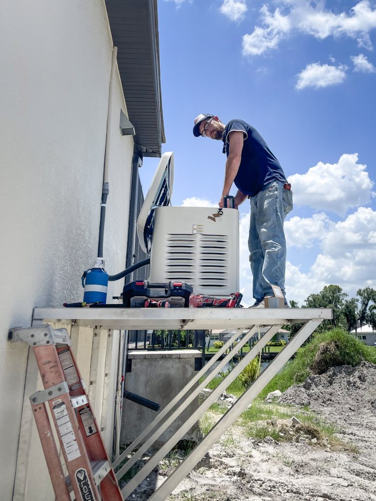 Technician repairing outdoor air conditioning unit