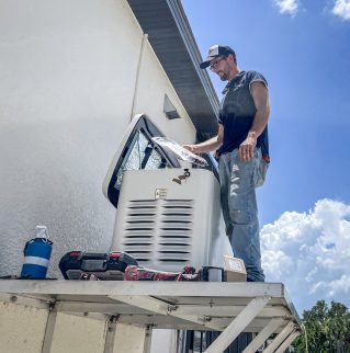 Technician repairing air conditioner outdoors
